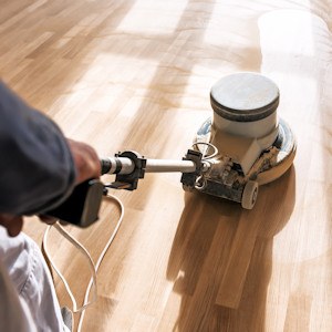 Prepping your hardwood floor for refinishing.